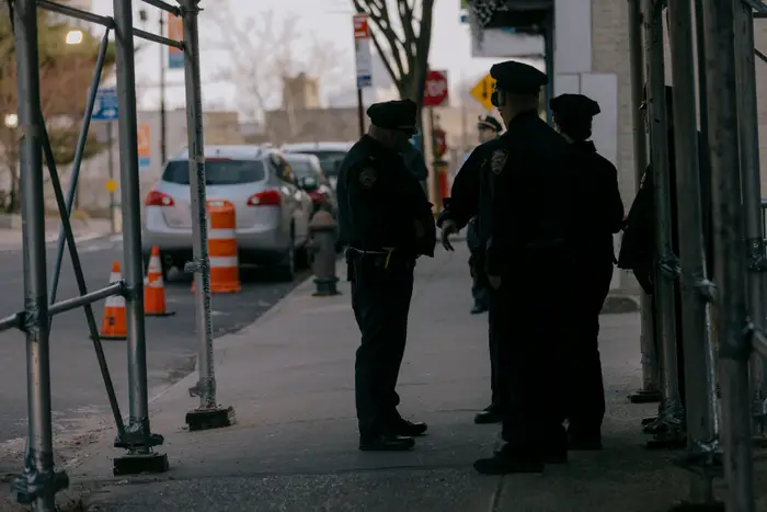 Officers convene under a scaffolding.